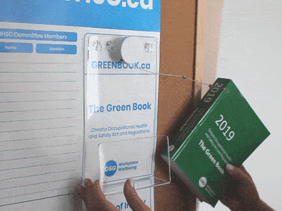 Green Book being inserted to Green Book Holder