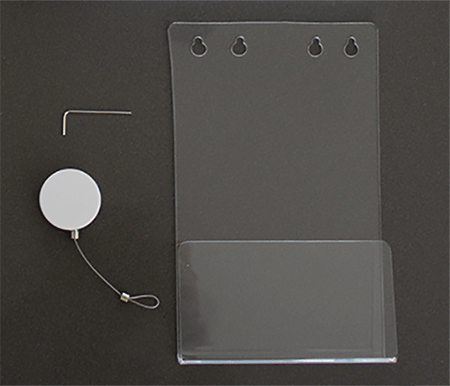 Green Book Holder (clear plastic), Allen key and retractable cord laid out on table