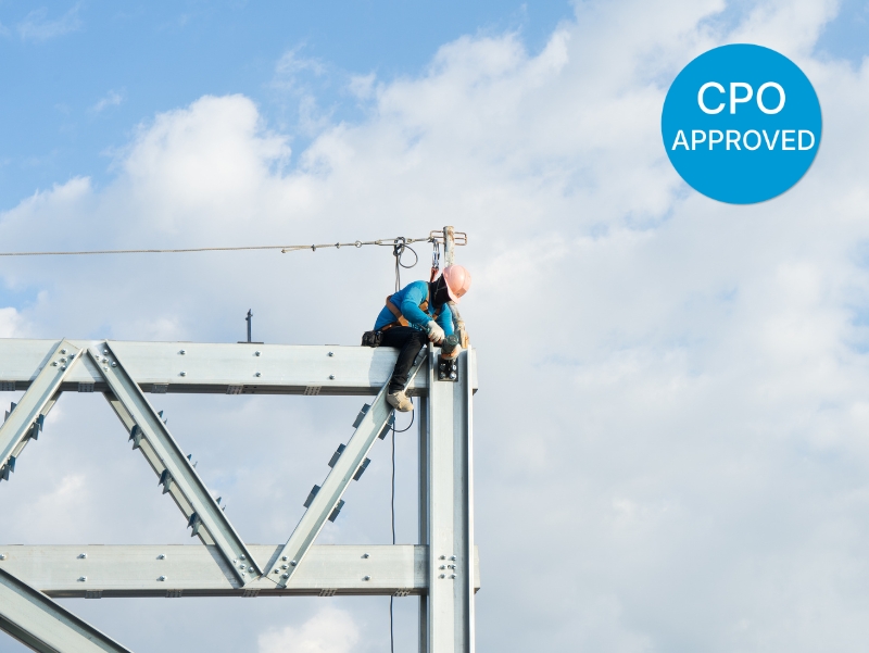 A construction worker secured on a steel structure following CPO-approved Working at Heights Refresher Training.